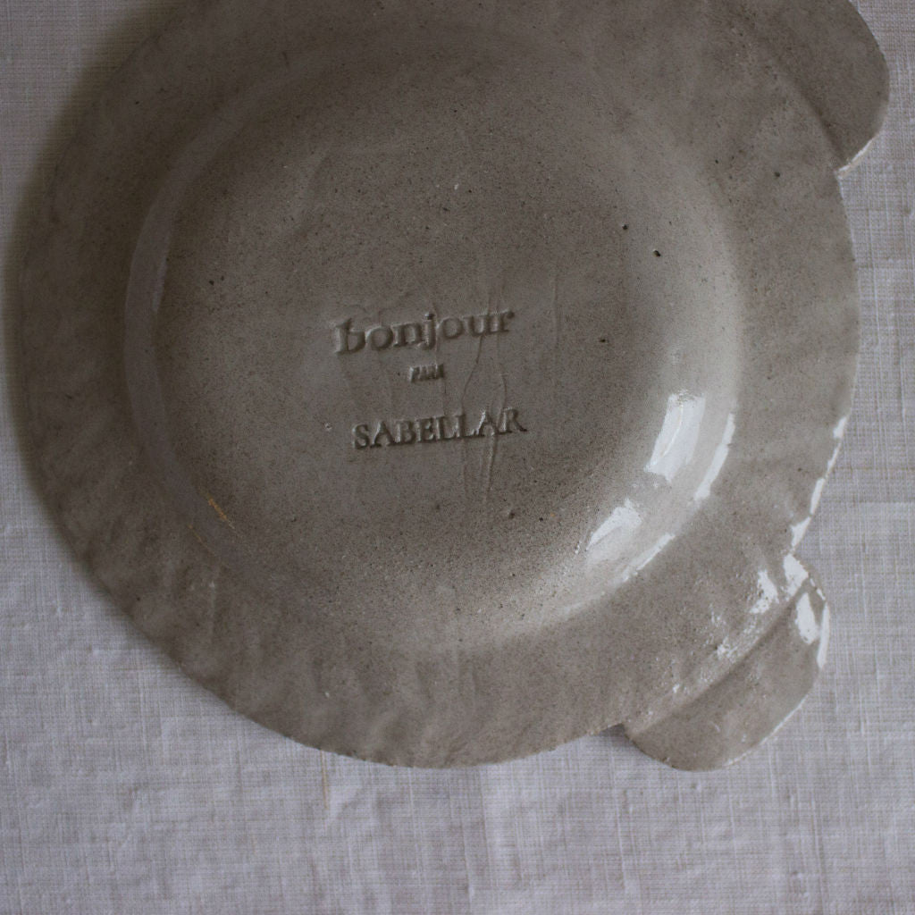 Back of the clay plate with Sabellar and Bonjour logos
