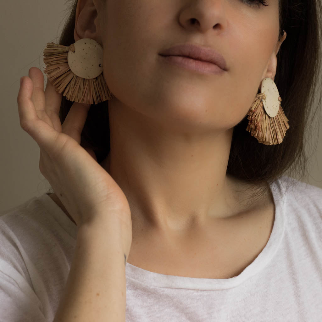 pair of earrings. ceramic and raffia earrings from verbena and sabellar. 