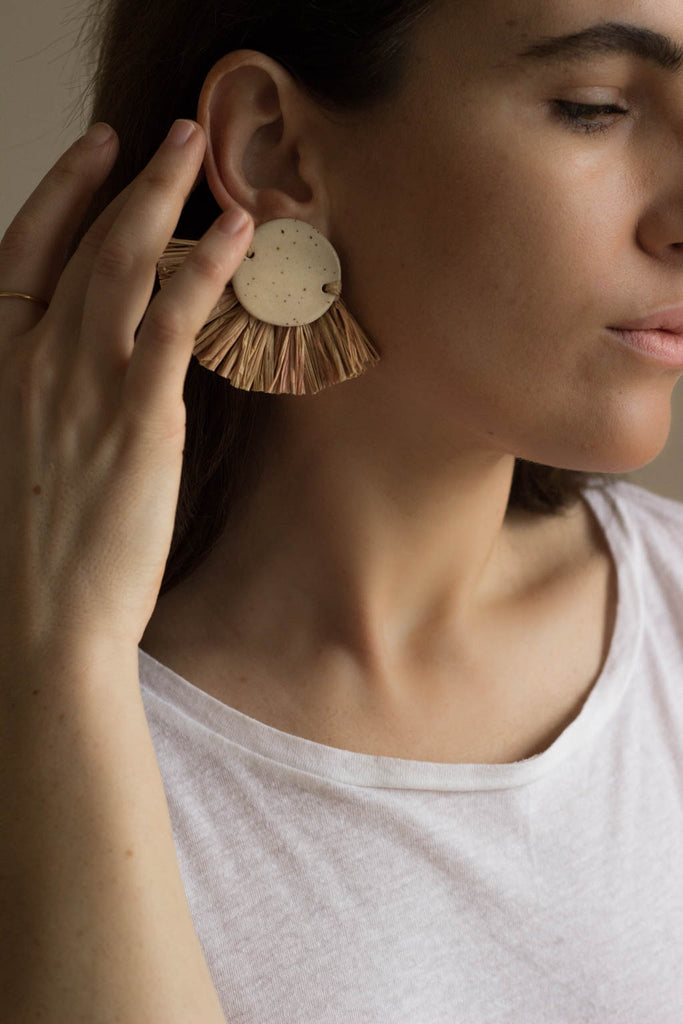 ceramic and raffia earrings from verbena and sabellar on model. 